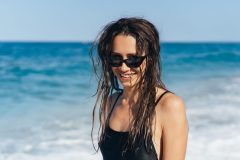 Beautiful young woman in black wet swimsuit